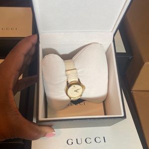 Women’s cream Gucci watch